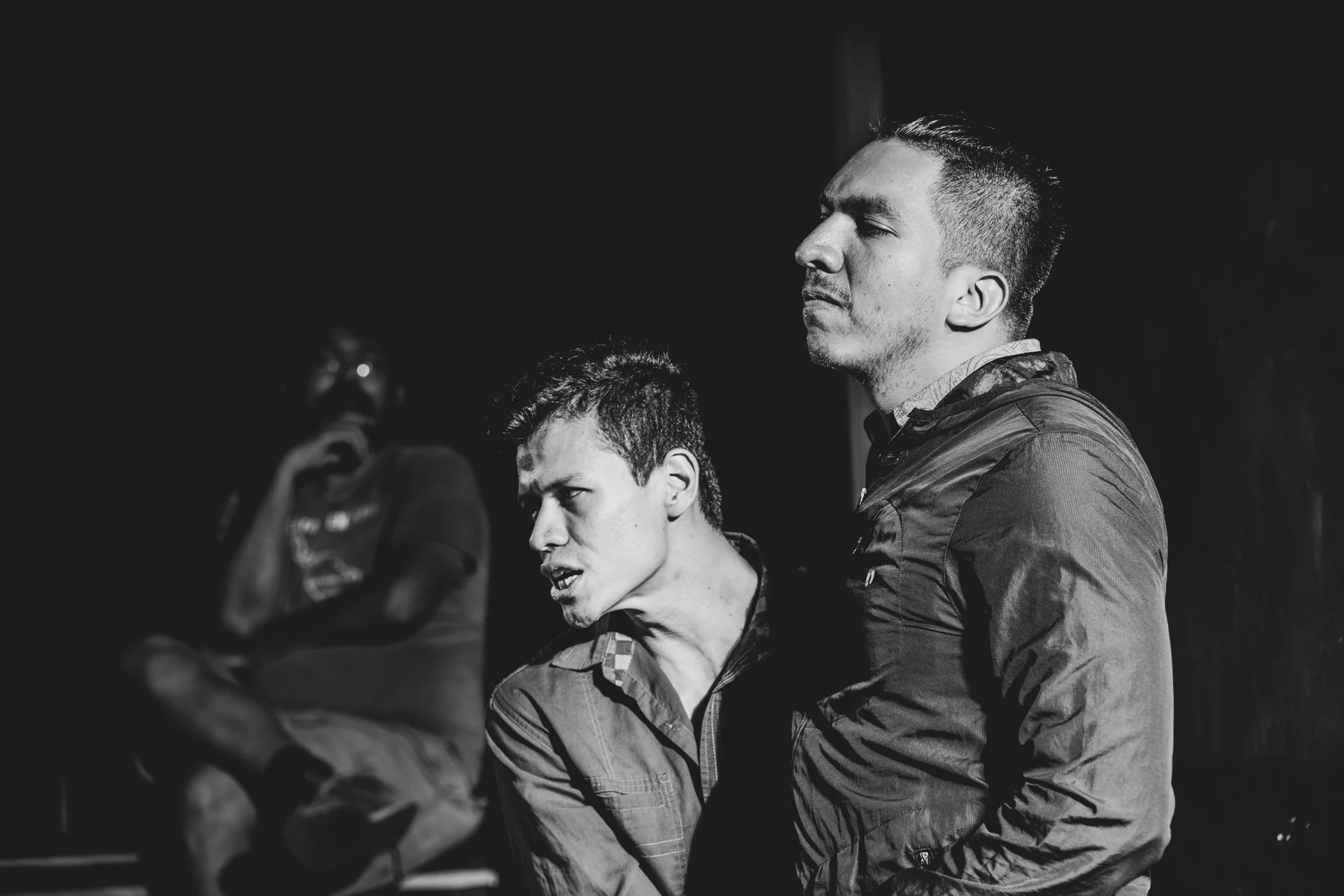 Two performers in a close black-and-white theatre scene